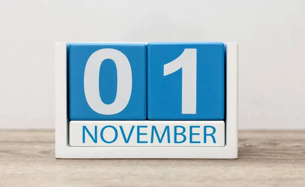 November 1st. Day 1 of month, wooden color calendar on light background. Autumn time.