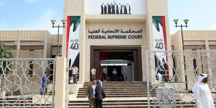 People stand outside the federal supreme court in Abu Dhabi November 27, 2011. REUTERS/Nikhil Monteiro